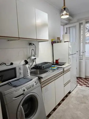a kitchen with a washing machine and a refrigerator at Apartman Moon in Belgrade