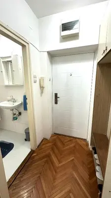 a bathroom with a white door and a sink at Apartman Moon in Belgrade