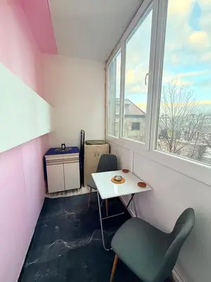 a small room with a table and a chair and a window at Apartman Moon in Belgrade
