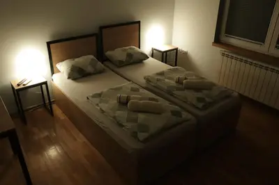 a bedroom with a large bed with two pillows at Apartments Peka in Dušanovac (historical)