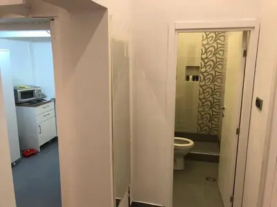 a bathroom with a toilet and a sink and a microwave at Apartman 4 you Downtown in Belgrade