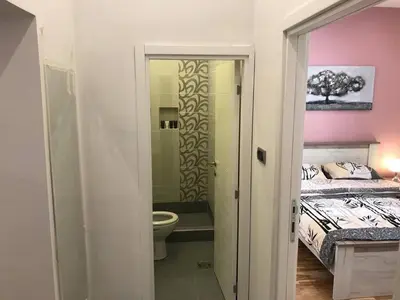 a bathroom with a bed and a toilet in a room at Apartman 4 you Downtown in Belgrade