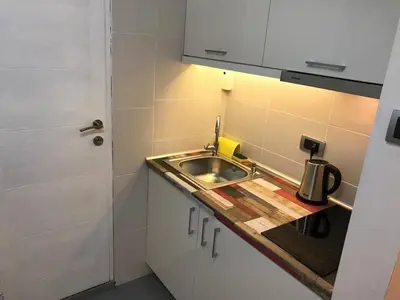 a small kitchen with a sink and a counter at Apartman 4 you Downtown in Belgrade