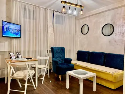 a living room with a couch and a table and chairs at Arena Belgrade in Novi Beograd