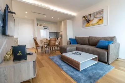 a living room with a couch and a table at Apartments Royal - Sakura Park in Novi Beograd