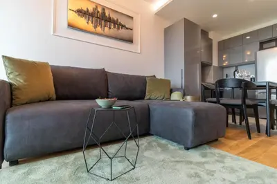 a living room with a couch and a table at Apartments Royal - Sakura Park in Novi Beograd