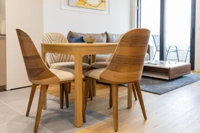 a dining room table and chairs with a couch at Apartments Royal - Sakura Park in Novi Beograd