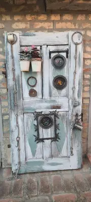 an old wooden door with potted plants on it at Imanje sa bazenom in Obrenovac