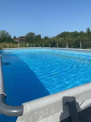 a large swimming pool with blue water at Obedska Bara - Kupinovo Retreat House in Kupinovo