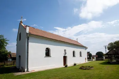 a small white church with a red roof at Obedska Bara - Kupinovo Retreat House in Kupinovo