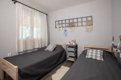a bedroom with two beds and a window at Obedska Bara - Kupinovo Retreat House in Kupinovo
