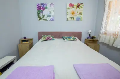 a bedroom with a bed with purple mats on it at Obedska Bara - Kupinovo Retreat House in Kupinovo