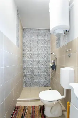 a small bathroom with a toilet and a shower at Obedska Bara - Kupinovo Retreat House in Kupinovo