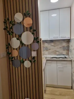 a kitchen with a wall with circles on it at Apartman DoDoLuLu in Belgrade