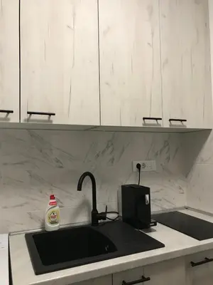 a kitchen counter with a sink and aounter at Apartman Oler in Smederevo