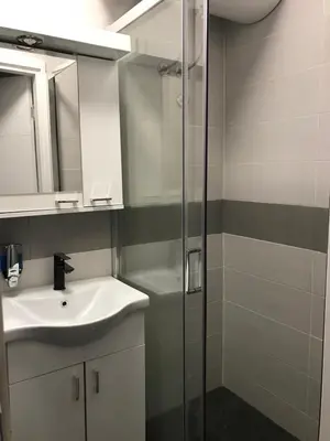 a bathroom with a sink and a shower at Apartman Oler in Smederevo