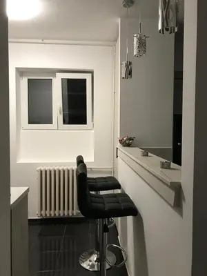 a black stool in a kitchen with a counter at Apartman Oler in Smederevo