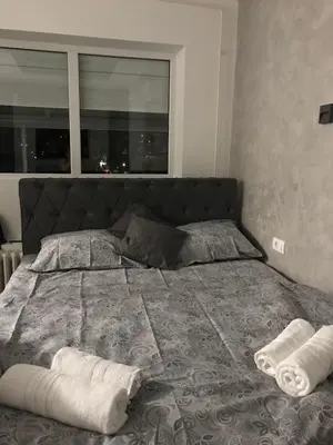 a bed with two towels on it in a bedroom at Apartman Oler in Smederevo