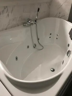 a large white bath tub in a bathroom at Apartman Oler in Smederevo