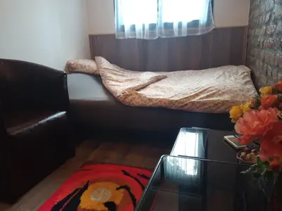 a small room with a bed and a glass table at Marmelo in Belgrade