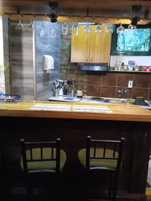 a kitchen with two chairs and a counter with a sink at Marmelo in Belgrade