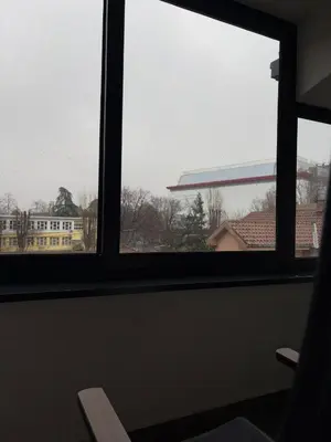 a window with a view of a building at Apartment SIA in Voždovac