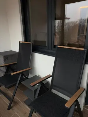 two chairs sitting in front of a window at Apartment SIA in Voždovac
