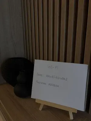 a sign sitting on a stand next to a vase at Apartment SIA in Voždovac