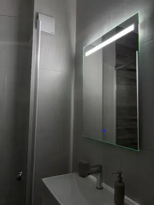 a bathroom with a sink and a mirror at Apartment SIA in Voždovac