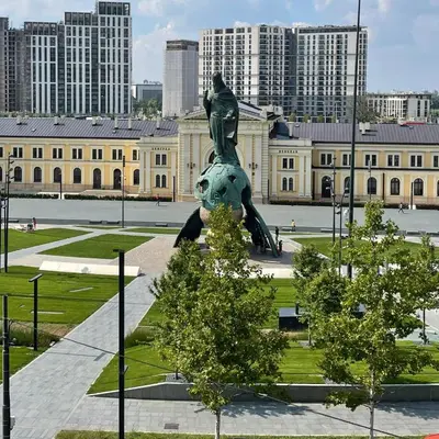 a statue in front of a large building at MOOW Belgrade Waterfront View Apartments in Belgrade