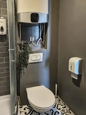 a bathroom with a toilet in a stall at MOOW Belgrade Waterfront View Apartments in Belgrade