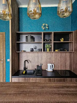 a kitchen with a sink and a blue wall at MOOW Belgrade Waterfront View Apartments in Belgrade