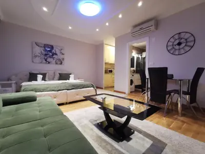 a living room with a bed and a coffee table at Fortuna Lux in Zvezdara