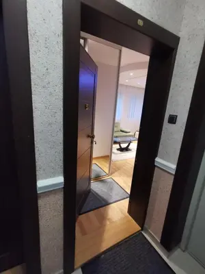 a mirror in a room with a door at Fortuna Lux in Zvezdara