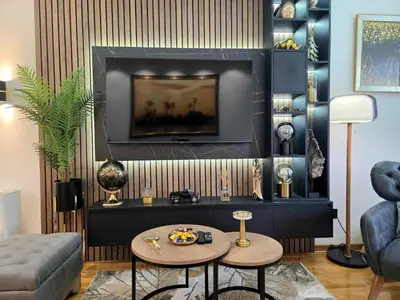 a living room with a tv and a table at Oaza apartmani in Arandjelovac