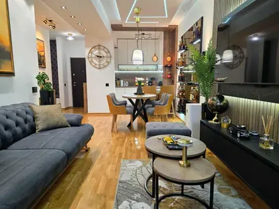 a living room with a couch and a table at Oaza apartmani in Arandjelovac