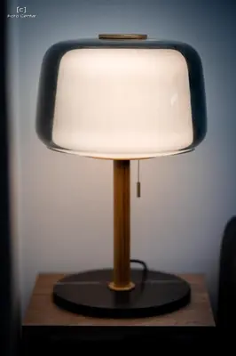a lamp sitting on top of a wooden table at Oaza apartmani in Arandjelovac