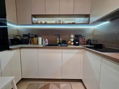 a kitchen with white cabinets and a sink at Oaza apartmani in Arandjelovac