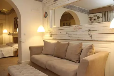 a couch sitting in a living room with a wall at VILA STASEA in Smederevo