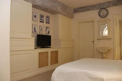 a bedroom with a bed and a tv on a wall at VILA STASEA in Smederevo