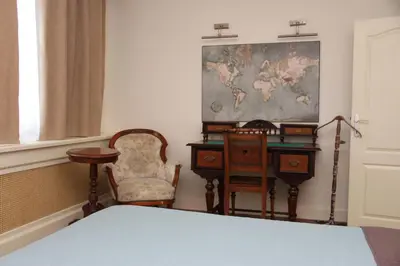 a bedroom with a bed and a desk and chairs at VILA STASEA in Smederevo