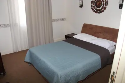 a bedroom with a bed with a blue blanket at VILA STASEA in Smederevo