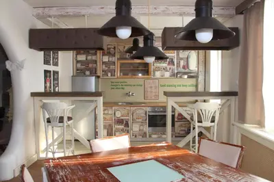 a dining room with a table and some lights at VILA STASEA in Smederevo