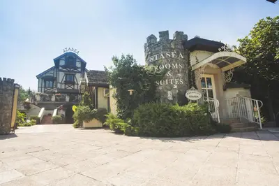 a building with a sign that reads palace rooms and suites at VILA STASEA in Smederevo