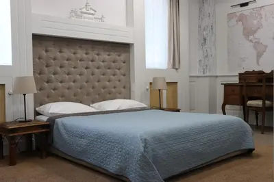 a bedroom with a large bed with a large headboard at VILA STASEA in Smederevo