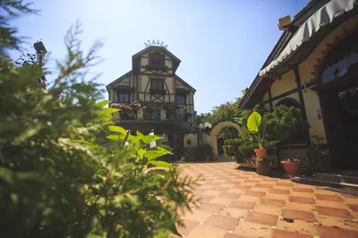a building with a clock tower in the middle of a courtyard at VILA STASEA in Smederevo