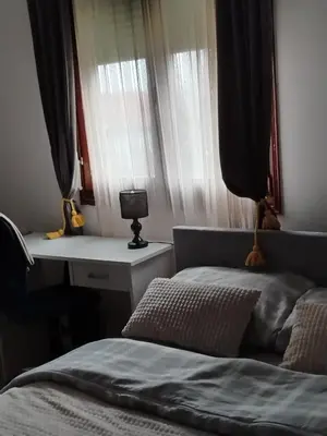 a bedroom with a bed and a desk with a lamp at \ua564 Comfy Home \ua564 - Make yourself at home in Belgrade