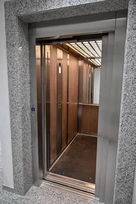 an elevator in a building with a glass door at Porto lux in Arandjelovac