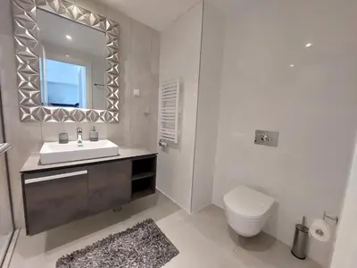 a bathroom with a sink and a toilet and a mirror at Belgrade Waterfront 1409 in Belgrade