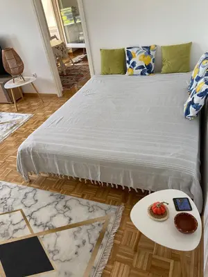 a bedroom with a bed with a tray of food on a table at Arena 011 in Novi Beograd